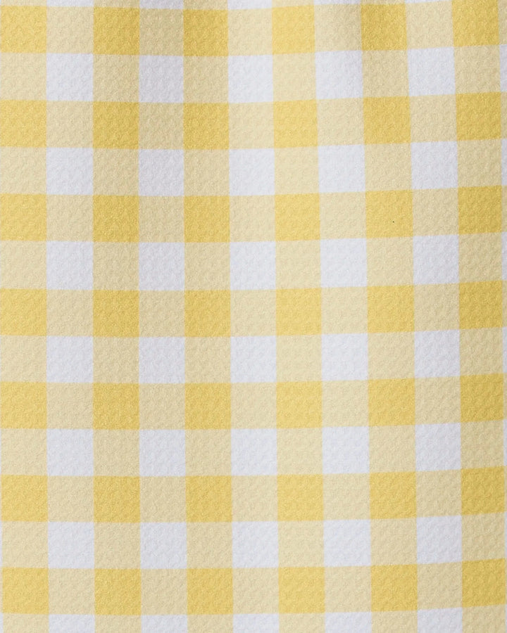 A close-up of GEOMETRY’s Lemon Gingham towel shows its yellow and white checkered pattern, featuring evenly spaced squares for a simple, classic, and ultra-absorbent design.