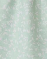 The Dandy towel by GEOMETRY features light mint green fabric with a subtle texture and delicate white floral vine pattern. Ultra-absorbent, it drapes softly for an elegant, functional touch in your space.