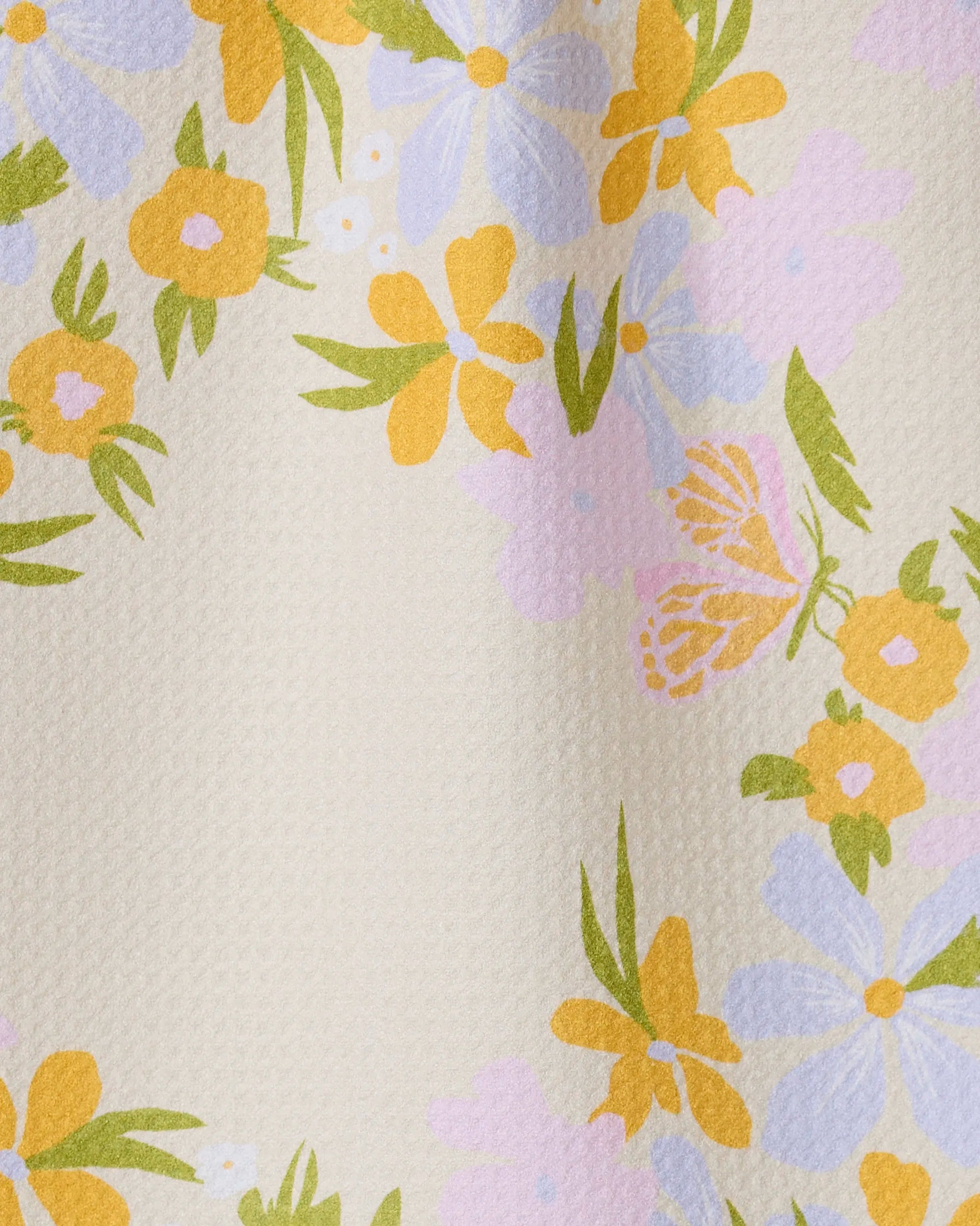 The GEOMETRY Abloom bar towel features a textured cream surface with clusters of yellow, lavender, and pink floral patterns and green leaves. Made from ultra-absorbent recycled materials, it blends beauty with practicality.
