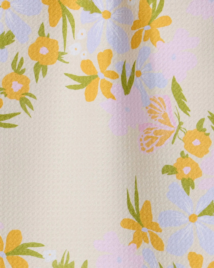 The GEOMETRY Abloom bar towel features a textured cream surface with clusters of yellow, lavender, and pink floral patterns and green leaves. Made from ultra-absorbent recycled materials, it blends beauty with practicality.