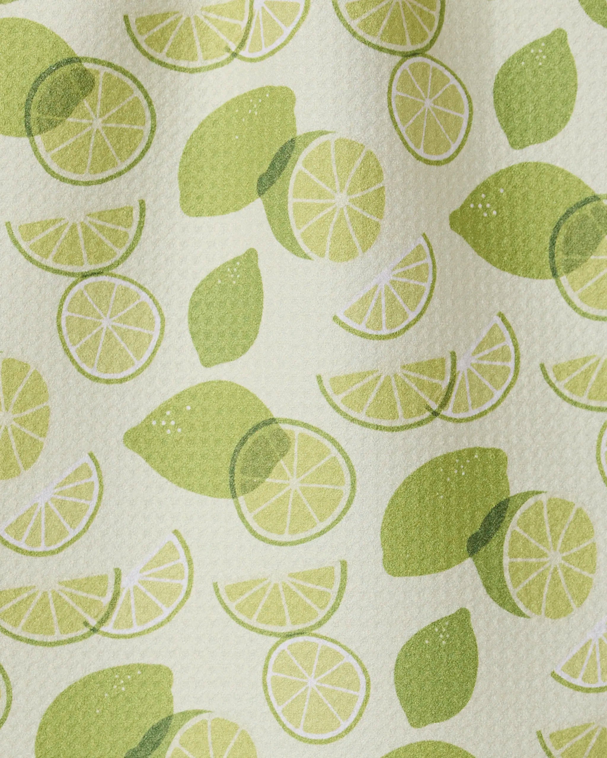 GEOMETRY’s “Limes” features whole limes, halves, and slices in green on a textured light background—ideal for an ultra-absorbent or recycled kitchen towel.