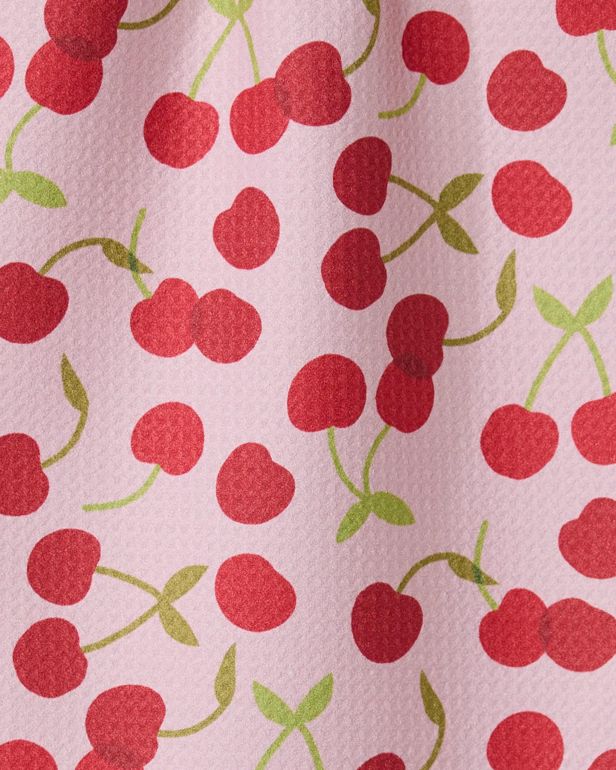 The GEOMETRY Cheery Cherries bar towel features a pink textured design with red cherries and green stems, made from recycled materials for an eco-friendly and ultra-absorbent option.