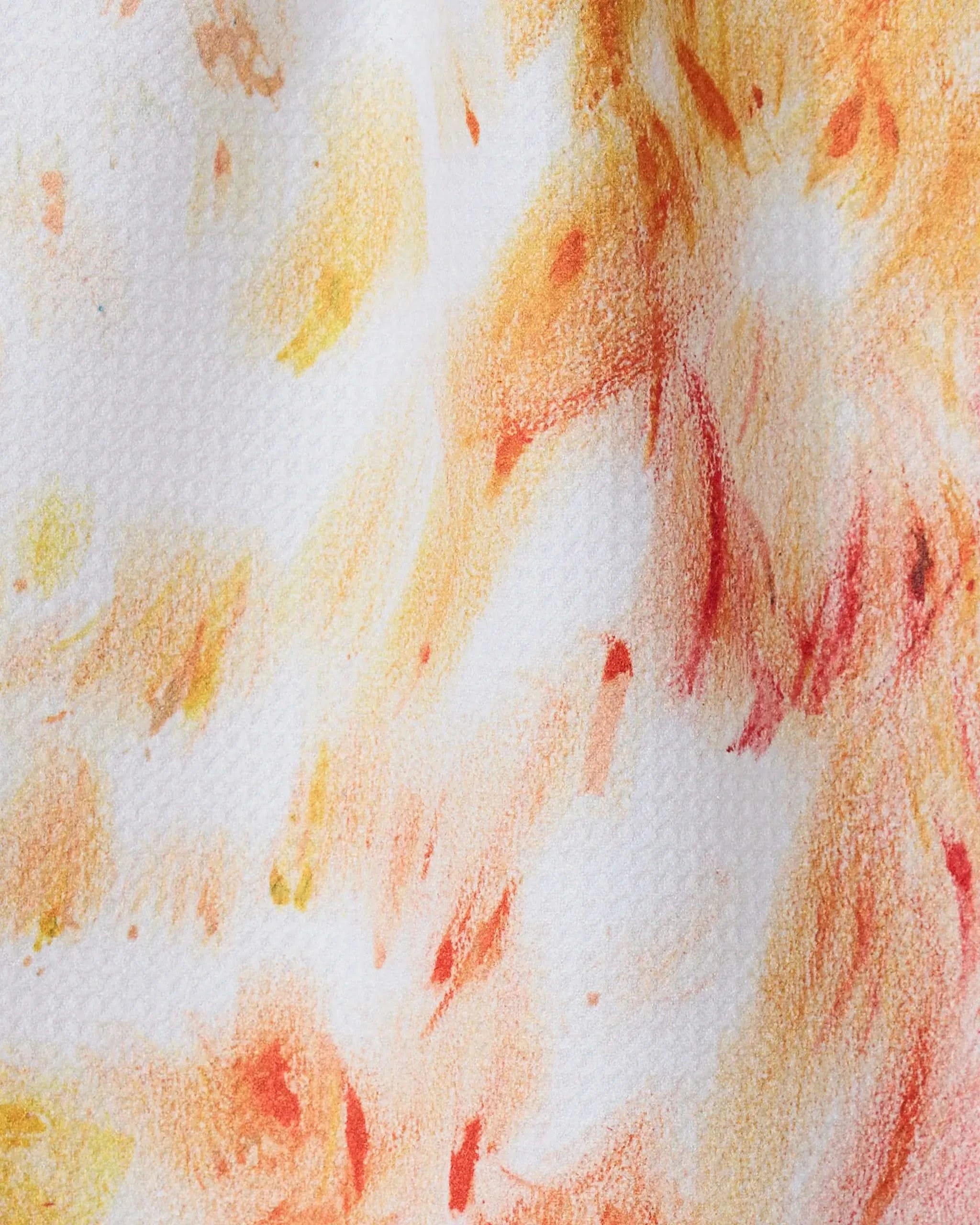 Waters Edge by GEOMETRY features an abstract orange, red, and yellow pattern on textured white—evoking warmth and movement. This ultra-absorbent towel is crafted from recycled materials, blending artful design with eco-friendly function.