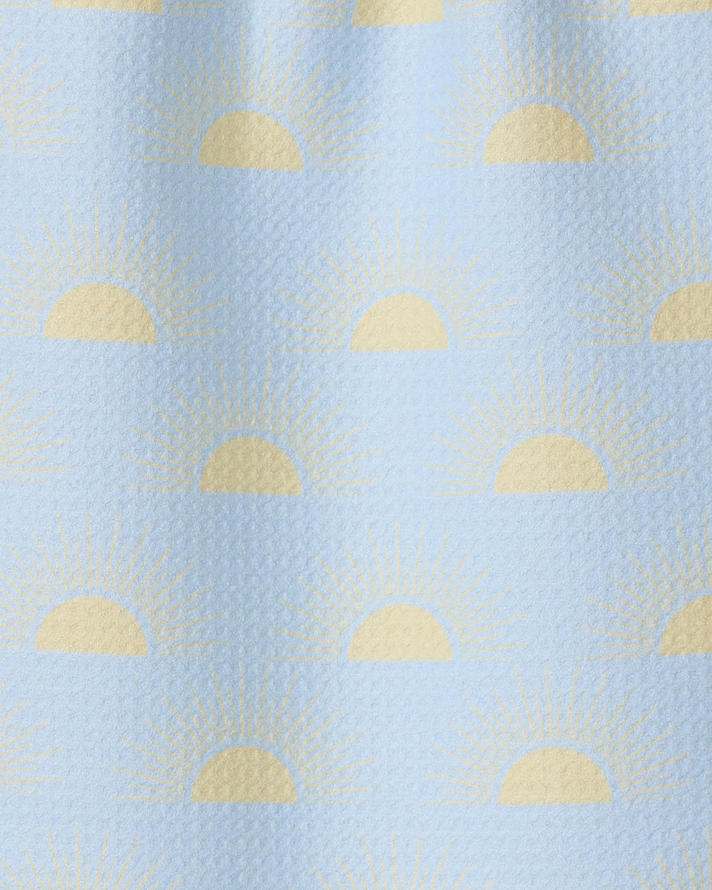 Soft Summer Sun by GEOMETRY is a light blue textured fabric made from recycled materials, featuring yellow half-sun sunrise motifs and radiating rays in an evenly spaced, repeating pattern.