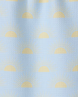 Soft Summer Sun by GEOMETRY is a light blue textured fabric made from recycled materials, featuring yellow half-sun sunrise motifs and radiating rays in an evenly spaced, repeating pattern.