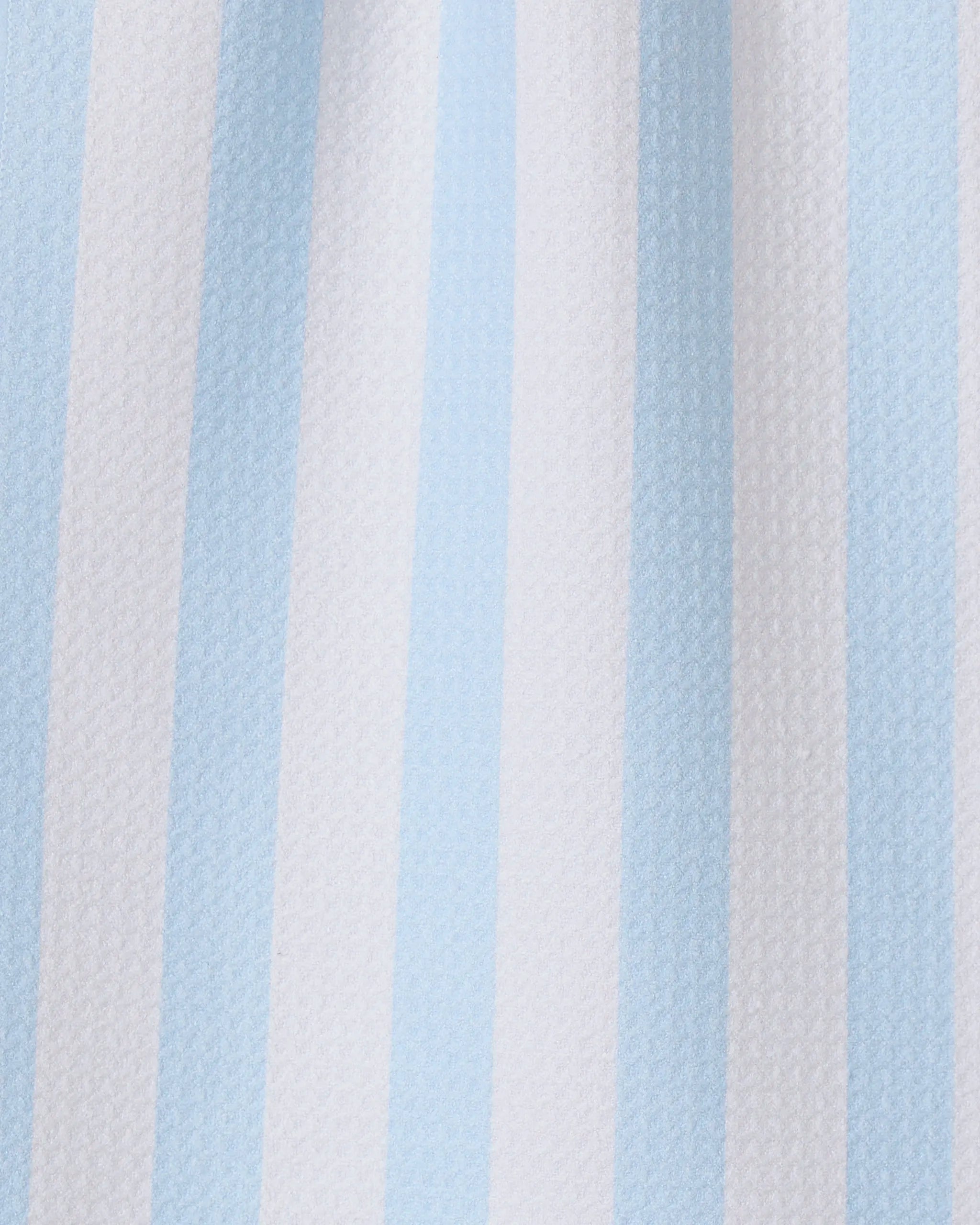 The GEOMETRY Seaside Stripes towel features vertical alternating pale blue and white stripes on textured fabric, making it a stylish and quick-drying choice for any kitchen.