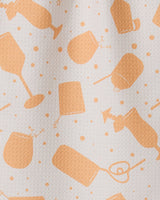 The GEOMETRY Bach Brunch bar towel is white with an orange pattern of drink glasses, cocktail shakers, ice cubes, and bubble-like dots. Made from ultra-absorbent recycled materials.