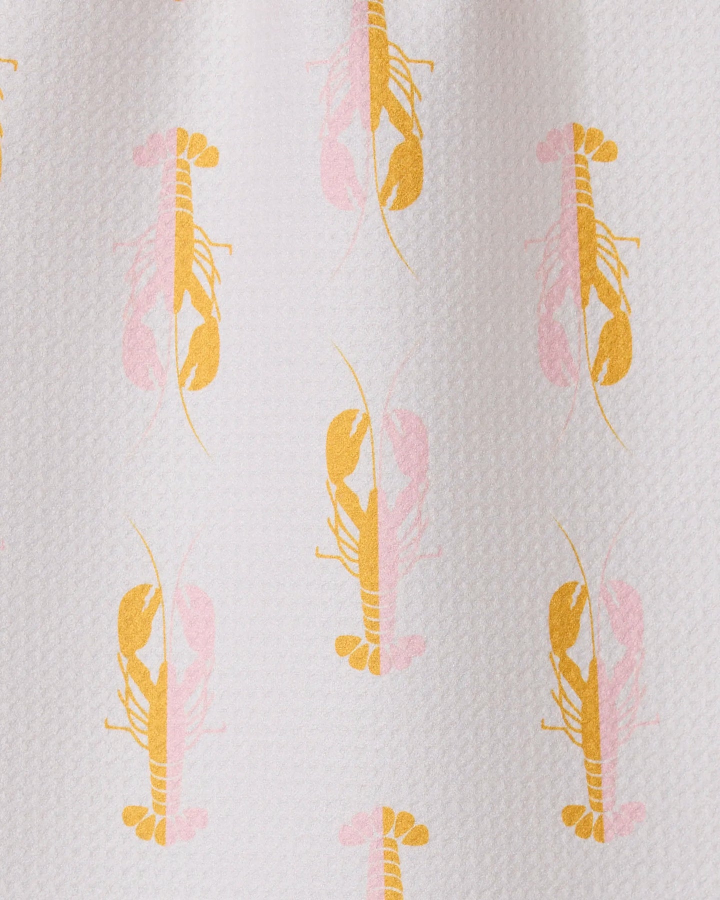 The GEOMETRY Lobster Love bar towel is textured white, made from recycled materials, and features a playful repeat pattern of yellow and light pink lobsters facing both up and down in alternating rows.