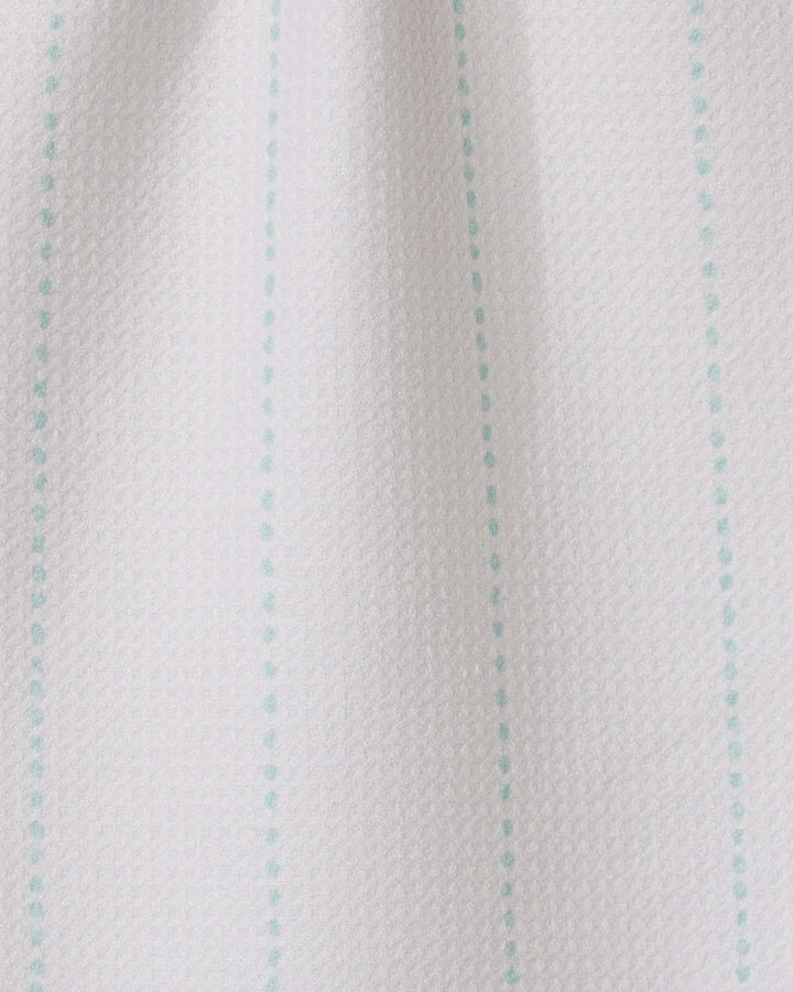 Close-up of GEOMETRY’s Dotted Dunes: white textured fabric featuring evenly spaced turquoise vertical dotted lines—a minimal, simple design perfect for ultra-absorbent towels made from recycled materials.