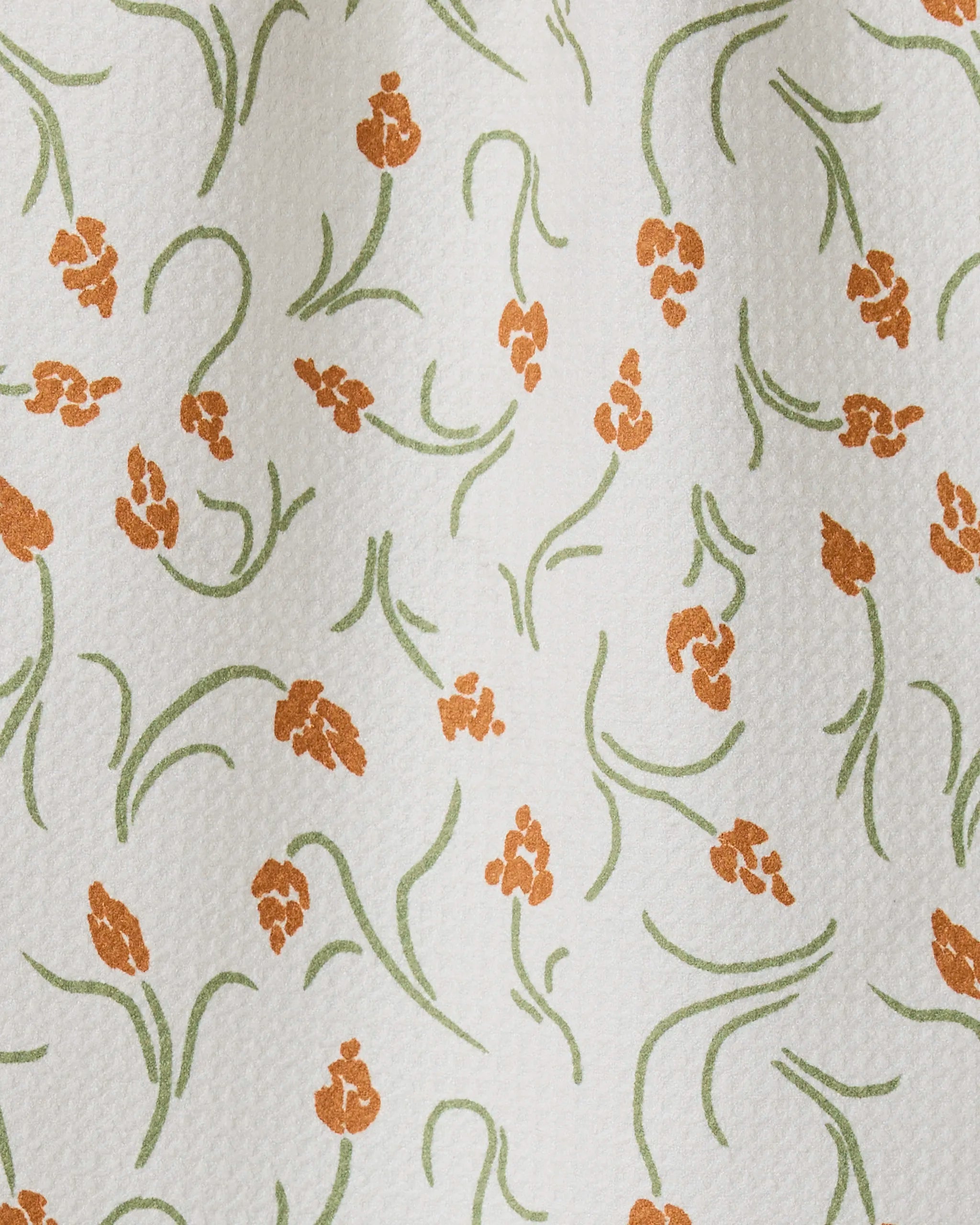 Crayon Floral by GEOMETRY: a white textured towel made from recycled materials, featuring small orange floral clusters with green stems and leaves—ultra-absorbent and perfect for kitchen or bar use.