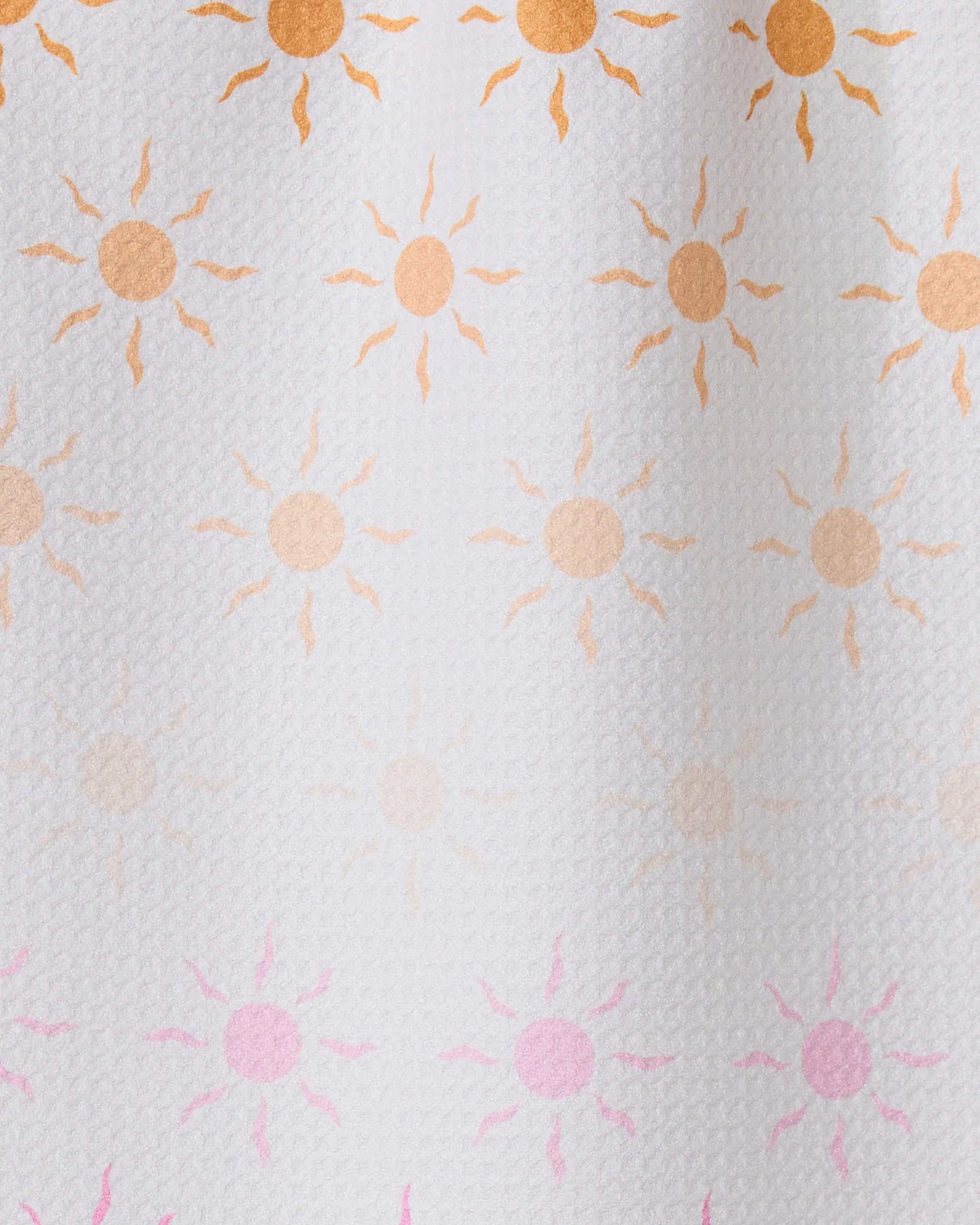 Fun in the Sun by GEOMETRY features rows of small sun patterns, orange fading to pink on textured white—ideal for inspiring an ultra-absorbent towel made from recycled materials.
