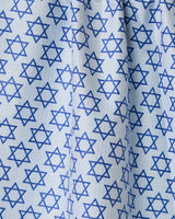 The Geometry Star Of David tea towel is light blue, quick-drying, and features a repeating dark blue Star of David pattern with a slight drape in the middle.