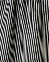 Close-up of black and white vertical stripes on the double-sided Lady tea towel by Geometry, showing folds and creases that create a wavy, textured pattern.