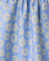 Close-up of Geometry’s Peri tea towel in light blue, featuring a quick-drying, textured fabric with simple white stylized flowers scattered throughout and gentle gathering along the top edge.