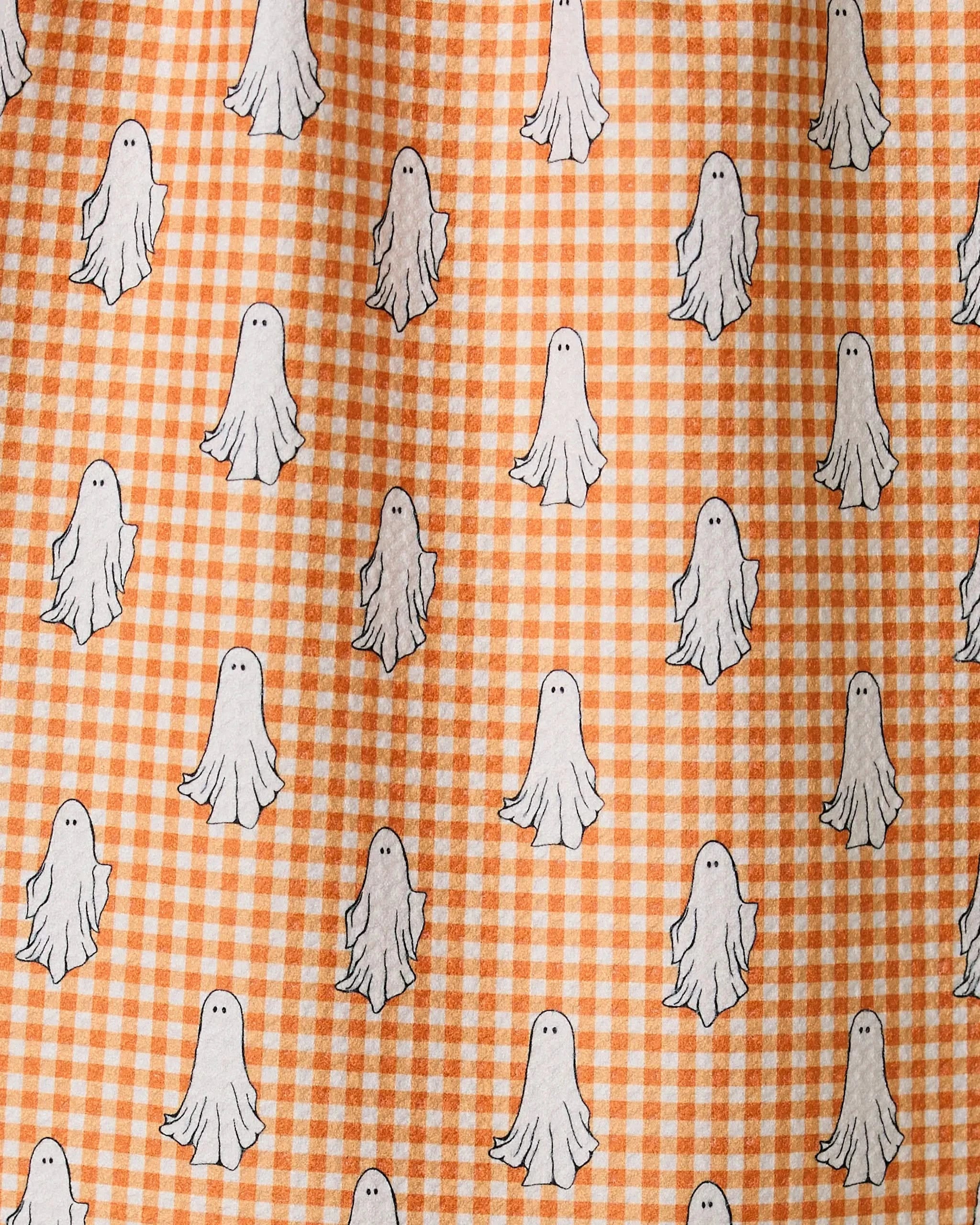 Geometrys Gingham Ghosts features orange and white gingham fabric decorated with small, cartoon white ghosts, all crafted from recycled materials for an eco-friendly touch.