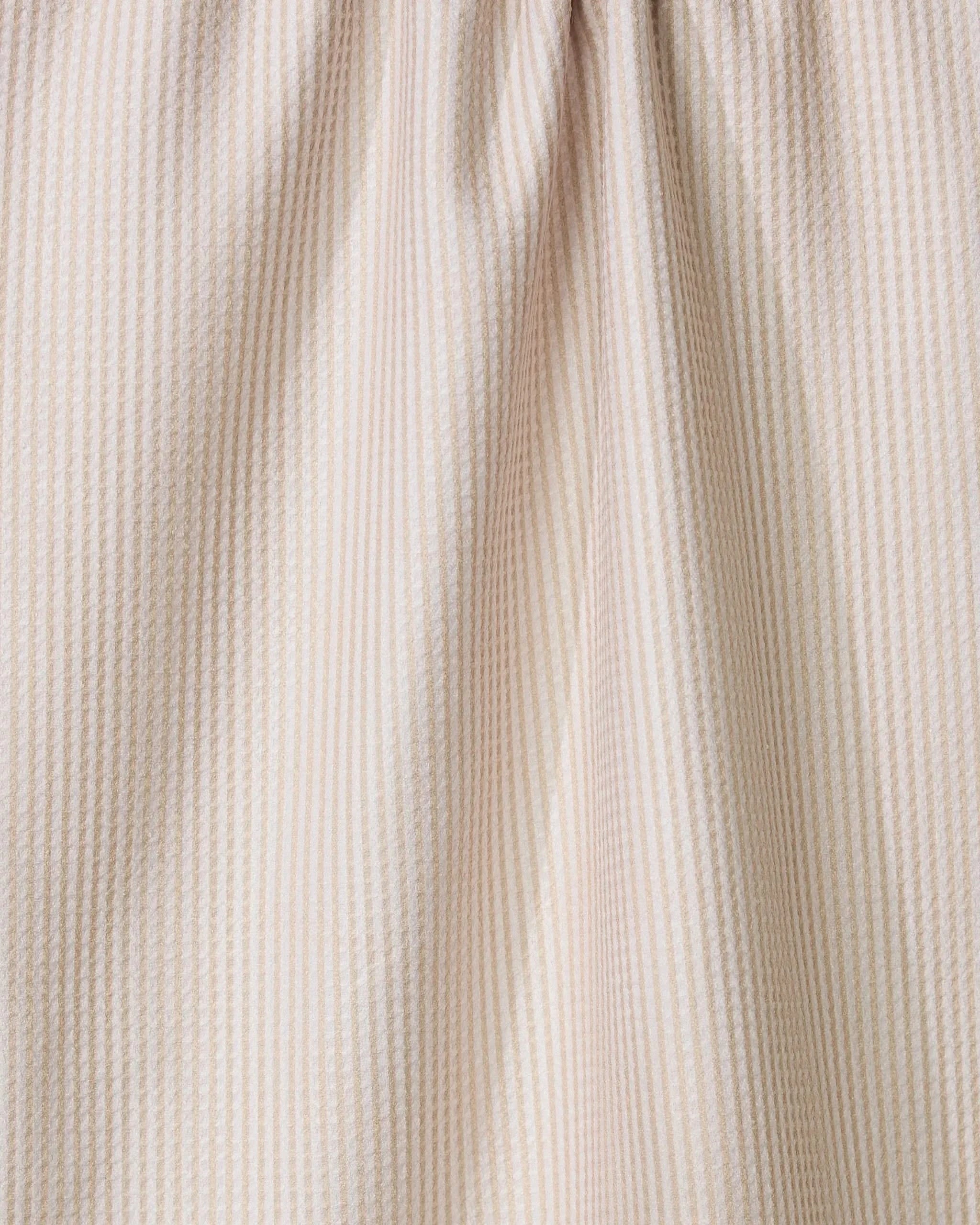 Close-up of the Geometry Gourdgeous ultra-absorbent tea towel in light beige, featuring thin vertical textured stripes and gathered folds at the top.