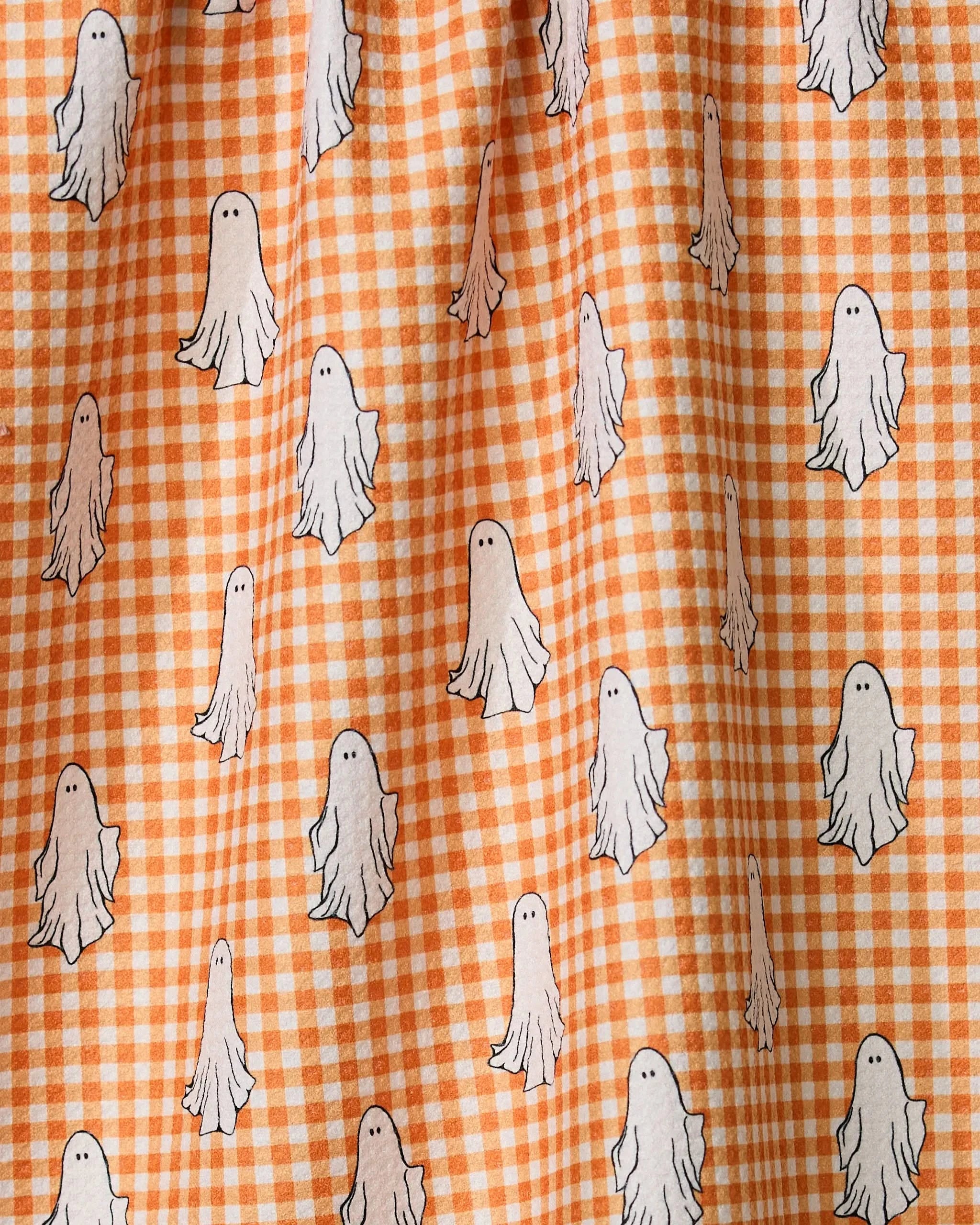 Gingham Ghosts by Geometry is an orange and white checkered tea towel featuring cute cartoon ghosts, made from ultra-absorbent recycled materials for a blend of style and function.