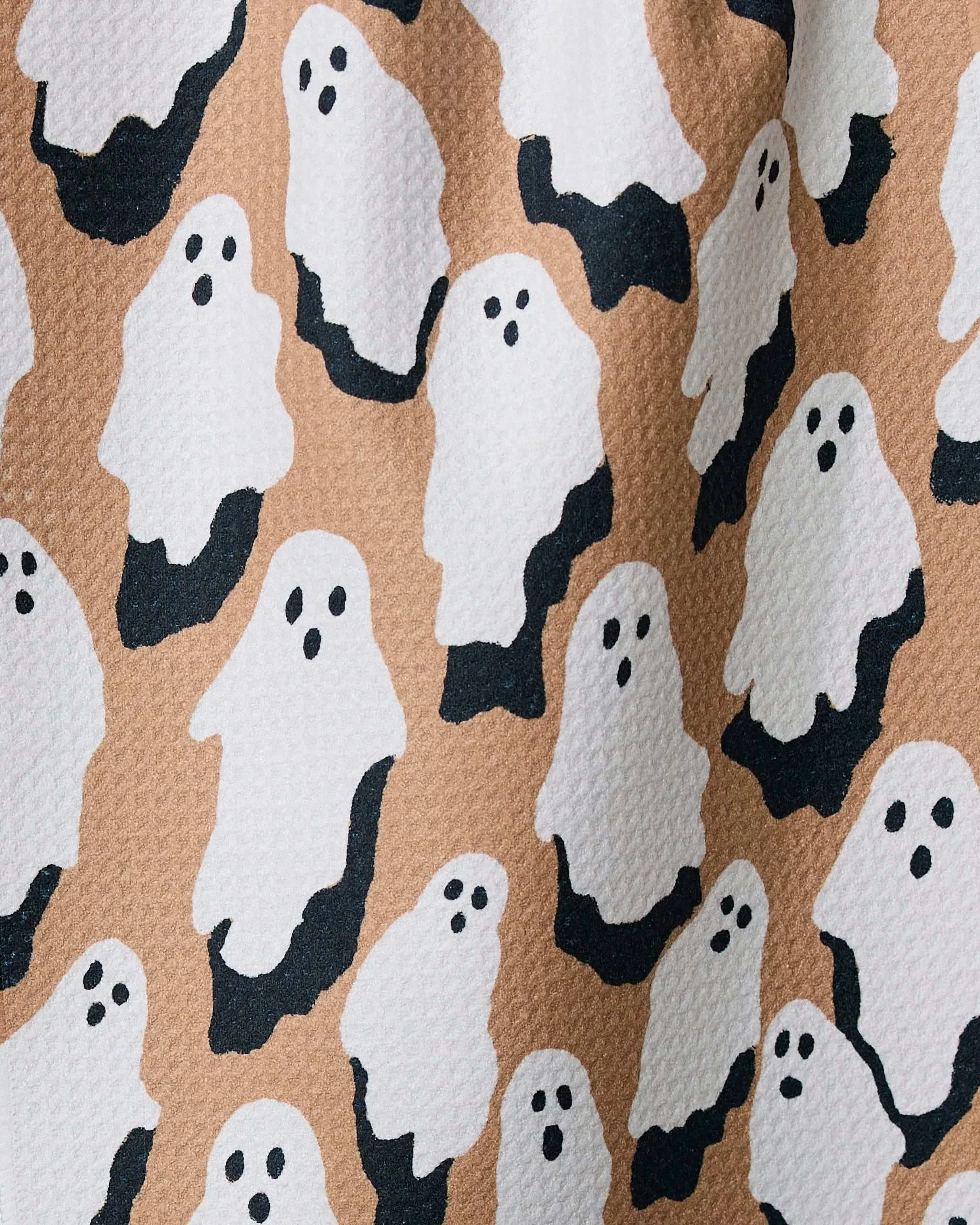 “My Boo” by Geometry features simple white ghosts with black eyes and mouths on a textured light brown background, creating a playful, repeating pattern—ideal for an ultra-absorbent or recycled kitchen towel.