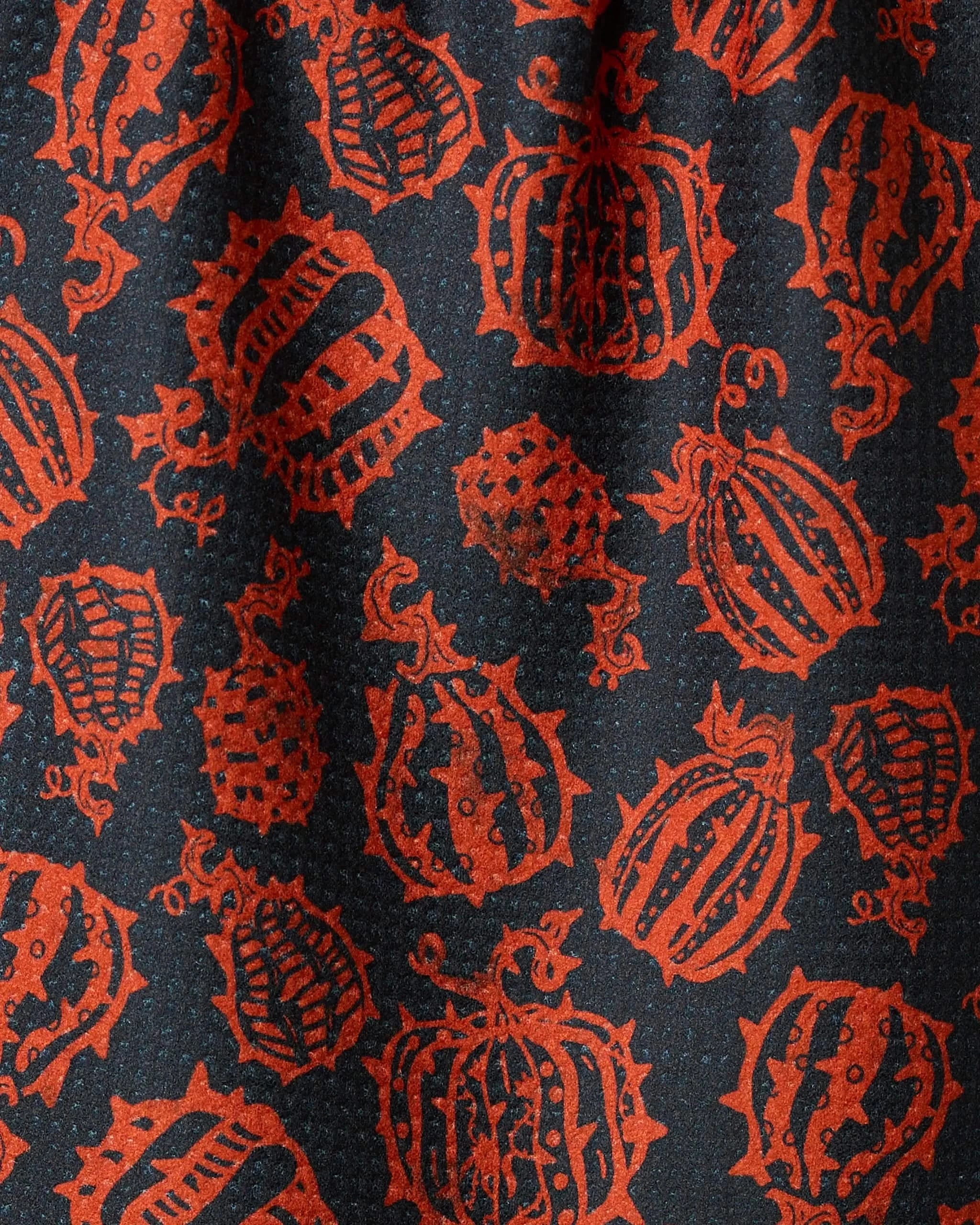 Punk Pumpkins Black by Geometry features bold black fabric with repeating orange, stylized gourd patterns accented by lines and dots—a whimsical, textured design perfect for an eco-friendly bar towel.