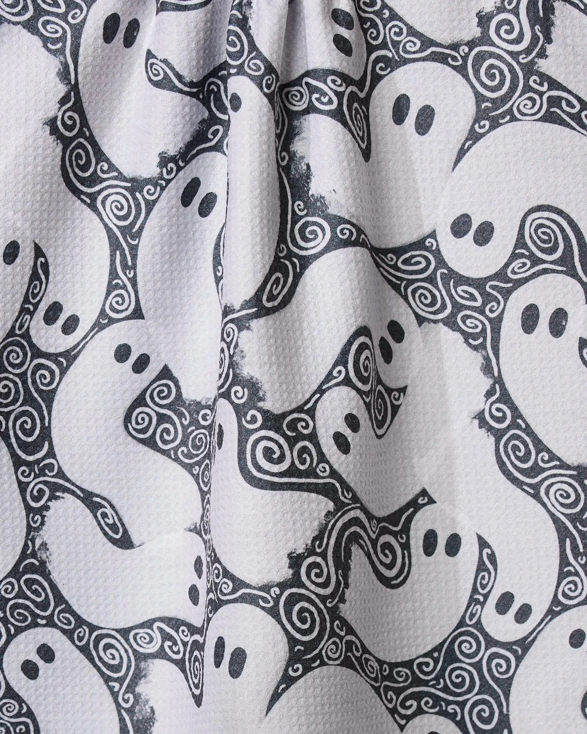The Geometry Swirling Ghosts tea towel features cartoon ghosts and swirling designs, made from ultra-absorbent recycled materials—perfect for a playful kitchen touch.