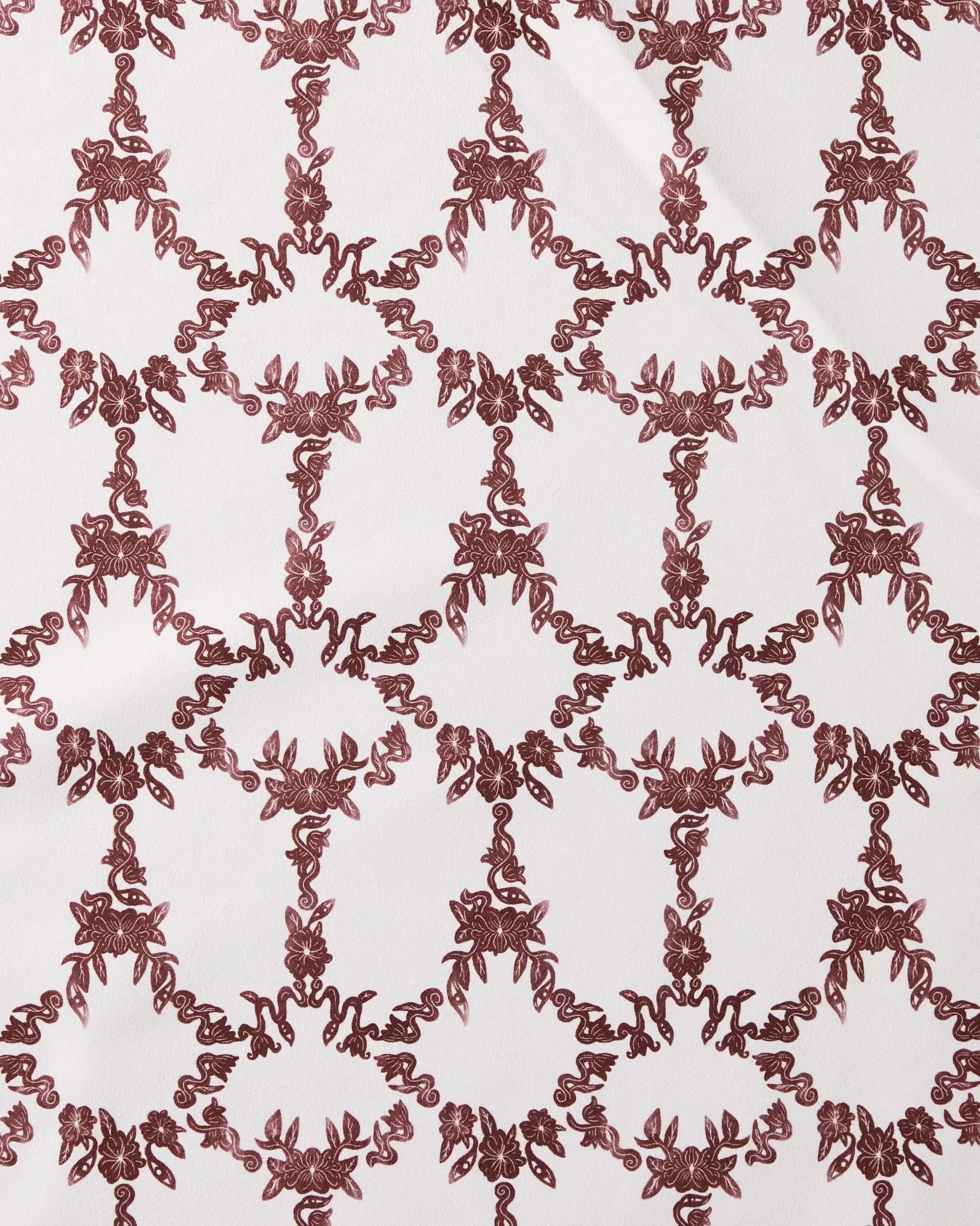 The Geometry Eye on You Floral napkin set features an ornate, symmetrical red floral and vine pattern on a white background, offering eco-friendly style for your table.