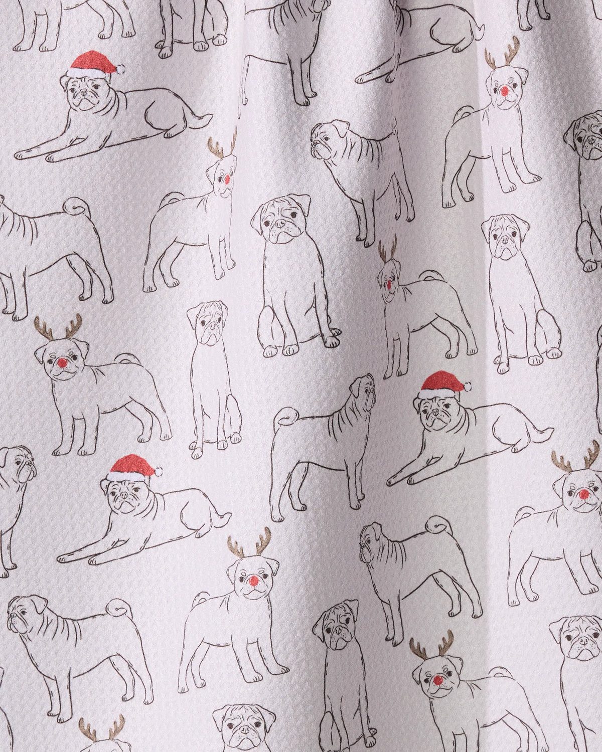The Festive Pugs kitchen towel by Geometry features playful pug sketches in holiday hats and antlers on textured white, made from recycled materials for a fun, eco-friendly touch.