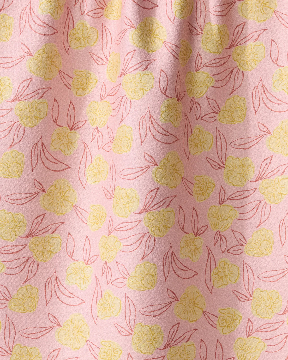 A Geometry Lucky Bloom recycled material tea towel featuring yellow flower outlines and red leaf sketches on a light pink background.