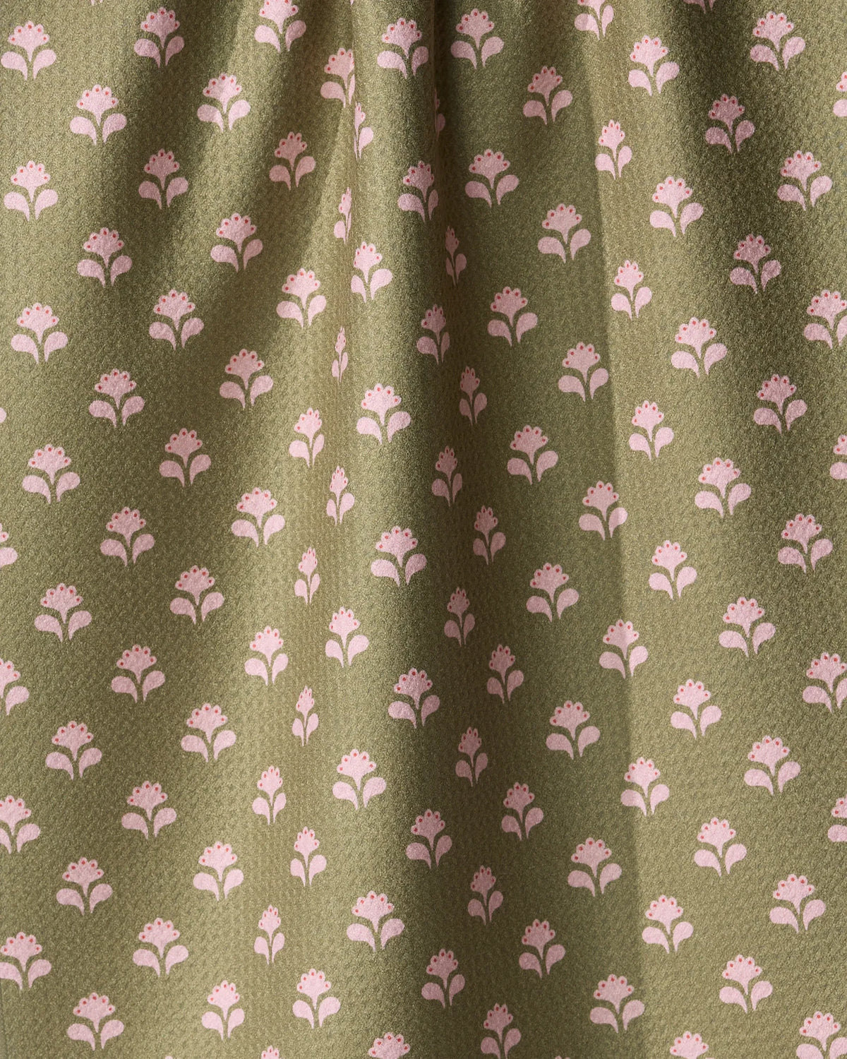 Lucky Flowers tea towel in an ultra-absorbent olive green fabric featuring a repeating pattern of small pink stylized flowers.