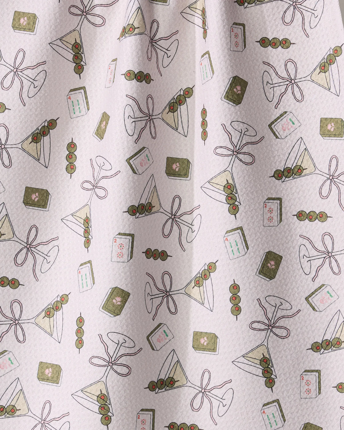 Geometry Martini Tiles tea towel featuring illustrations of martini glasses with olive garnishes, skewers of olives, and small rectangular tiles with numbers and floral motifs.