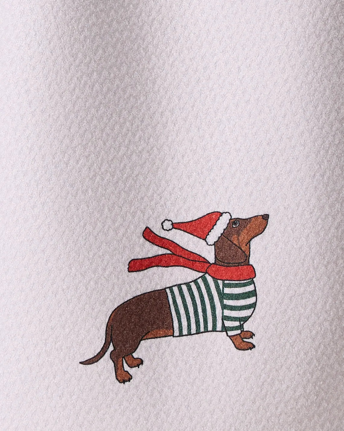 Merry Dachshund by Geometry: A brown dachshund in a green striped sweater and red Santa hat with scarf on a textured light background—ideal for a quick-drying tea towel made from recycled materials.