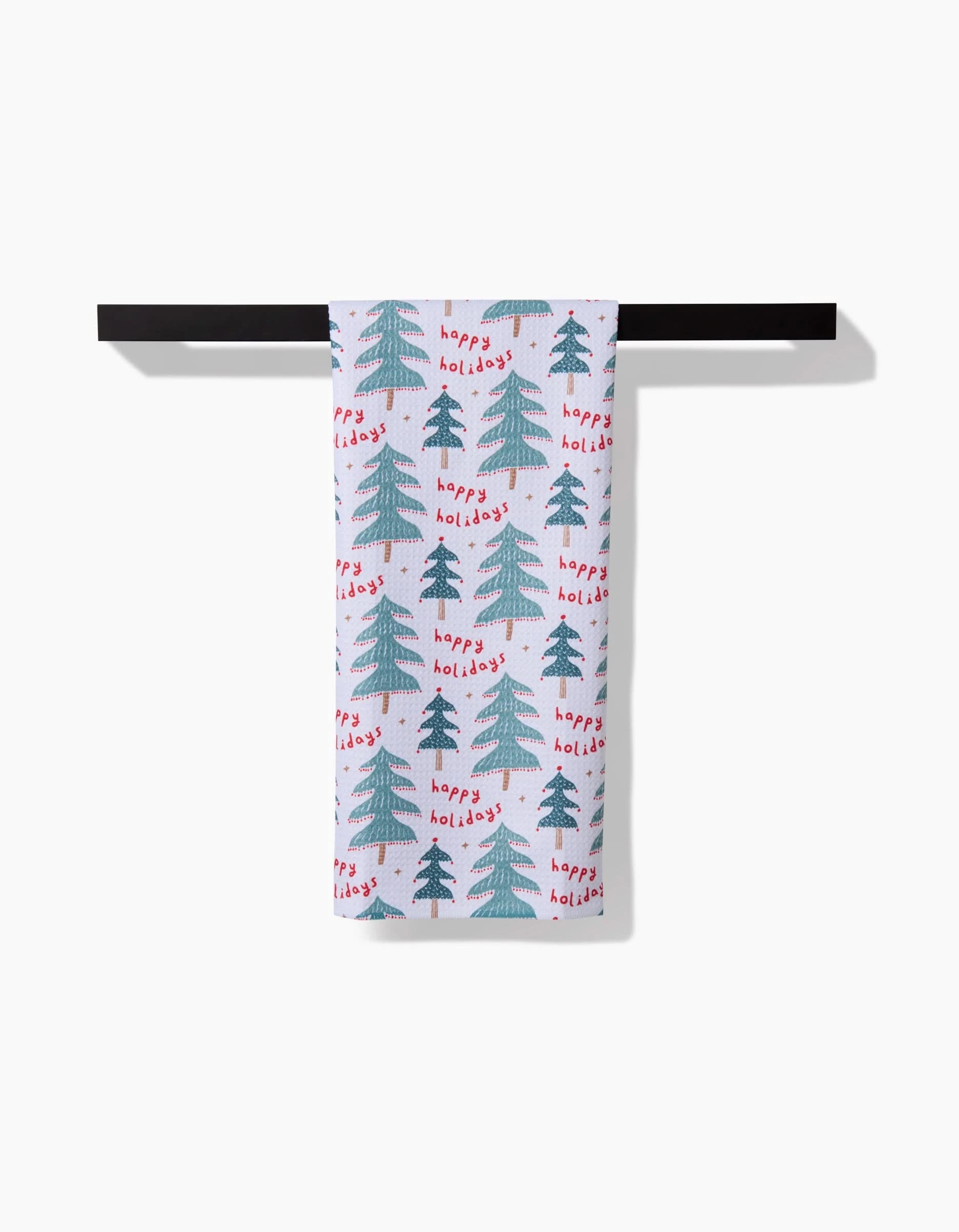 The Roxy Marj Berry Happy Holidays Luxe Hand Towel features green Christmas trees and red “happy holidays” text. Made with Geoweave technology, this quick-drying towel brings festive cheer to any space.