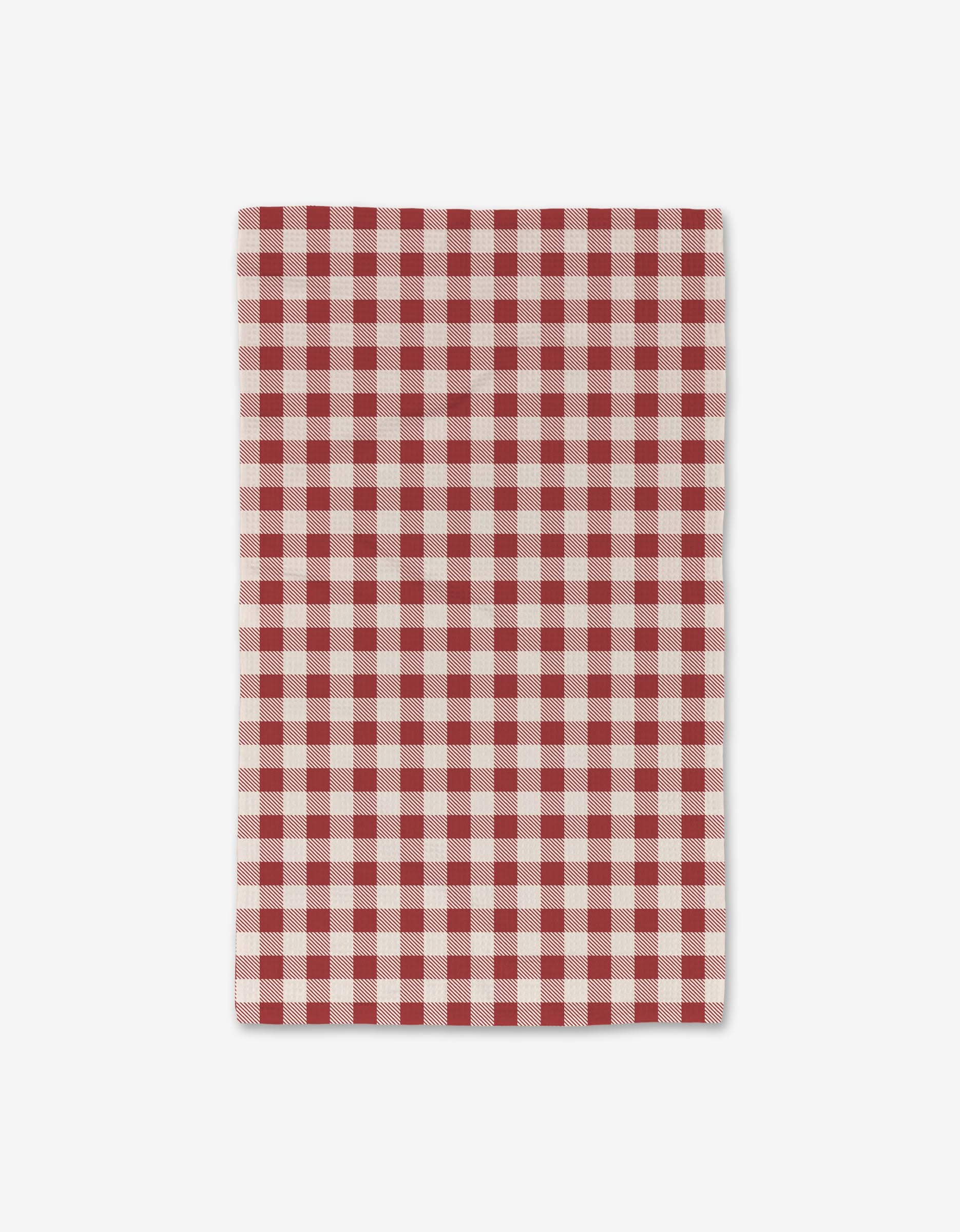 The Aubrey Fairchild Christmas Gingham Red is a rectangular cloth with a red and white checkered pattern. Ultra-absorbent and quick-drying, it’s shown against a plain white background.
