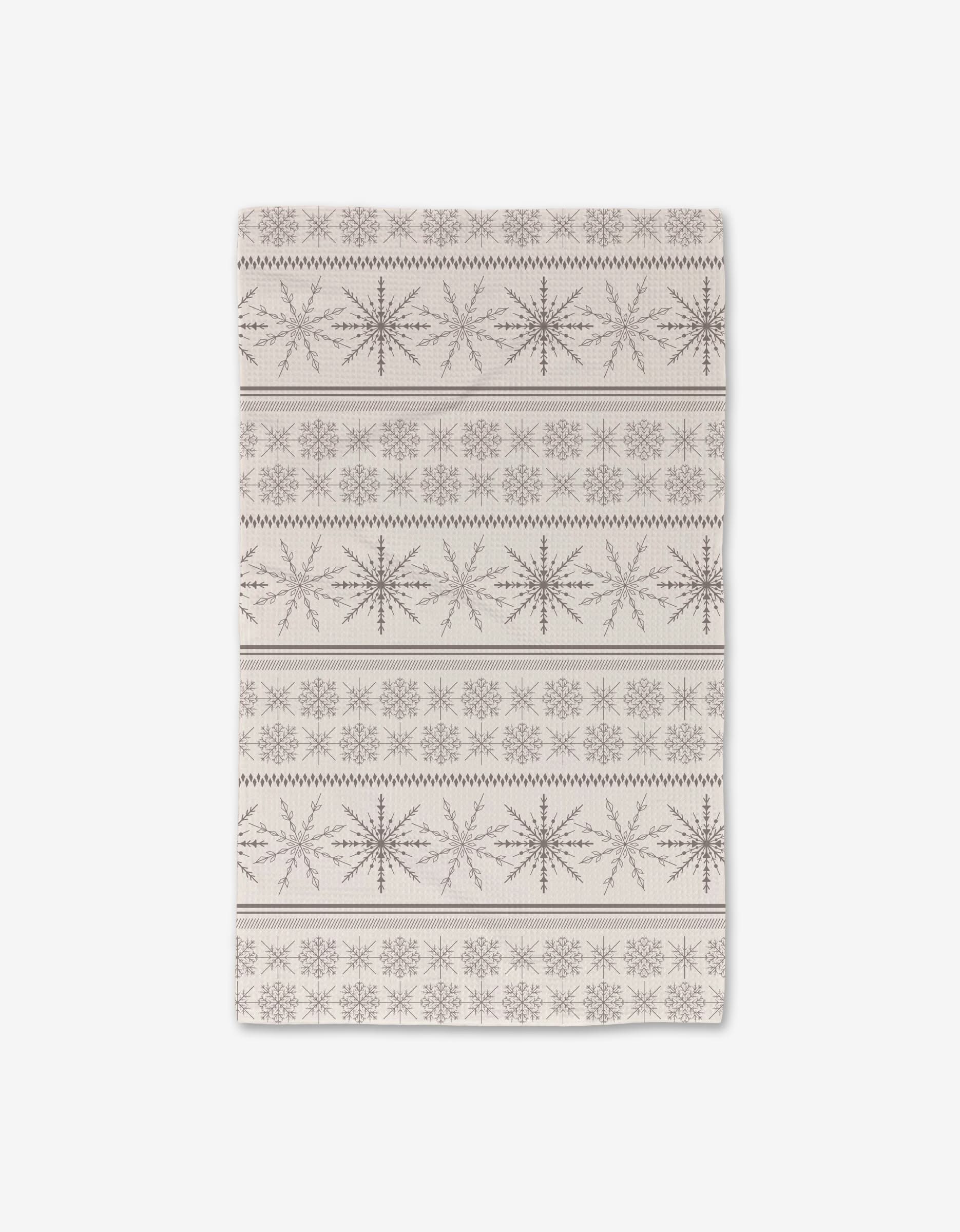 The Rosa Kichline Holiday Sweater showcases ultra-absorbent Geoweave tech and features dark brown geometric snowflakes with zigzag lines for a festive, winter-inspired rectangular beige design.