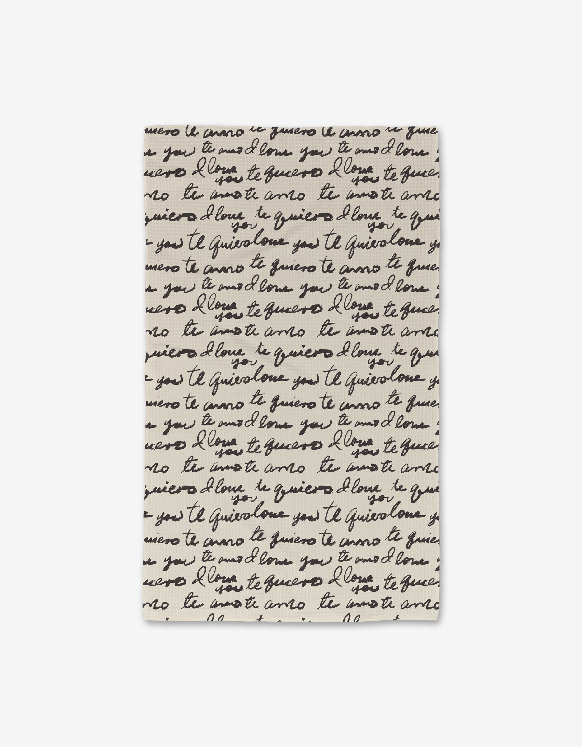 The Self Love Luxe Hand Towel by Danelys Sidron is a white, ultra-absorbent rectangular towel made from post-consumer recycled materials, featuring black cursive script with “te quiero,” “I love you,” and “ti amo.”.