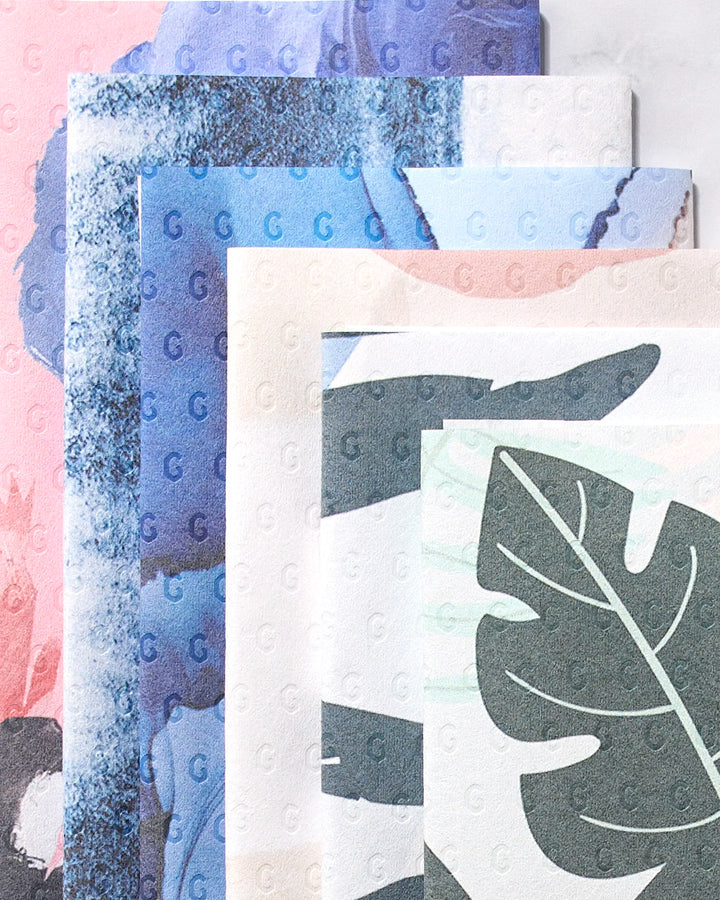 The GEOMETRY Artistic pack includes four sheets of patterned paper in pink, blue, beige, and green abstract designs. Made from post-consumer recycled materials, they're an eco-friendly choice for your creative projects.