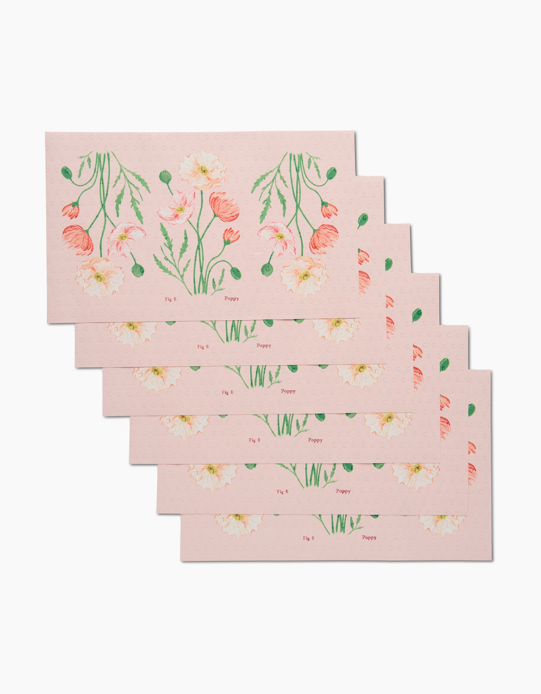 Five rectangular pink envelopes from Linda Fox’s August Poppy set are stacked, each featuring illustrated poppy flowers in pink, peach, and green. Made from eco-friendly recycled materials, August Poppy appears near the bottom of each envelope.