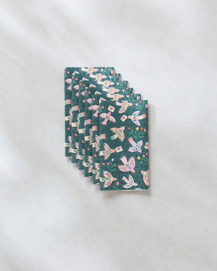 Six eco-friendly "Birdsong Post" kitchen towels by Ceyda Alasar, featuring vibrant fish, plants, and flowers on teal, are neatly stacked and offer an ideal alternative to recycled paper towels.