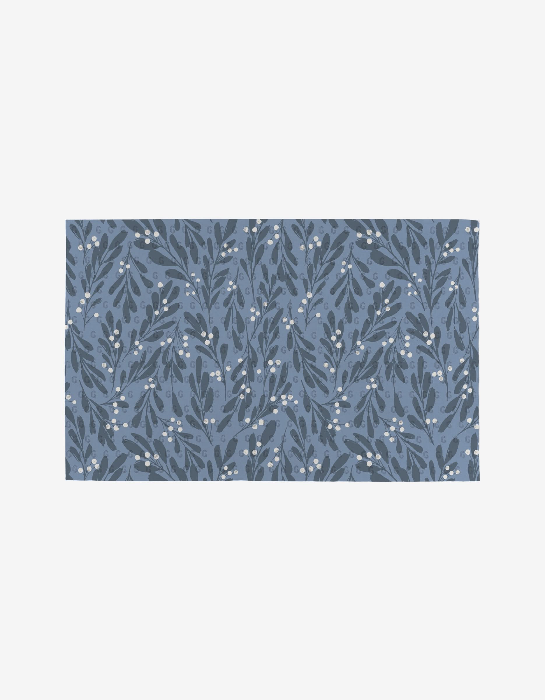 The Blue X-Mas rug by Hufton Studio is an eco-friendly, rectangular piece with a blue background, featuring nature-inspired leafy branches and white berries in darker blue and white accents.