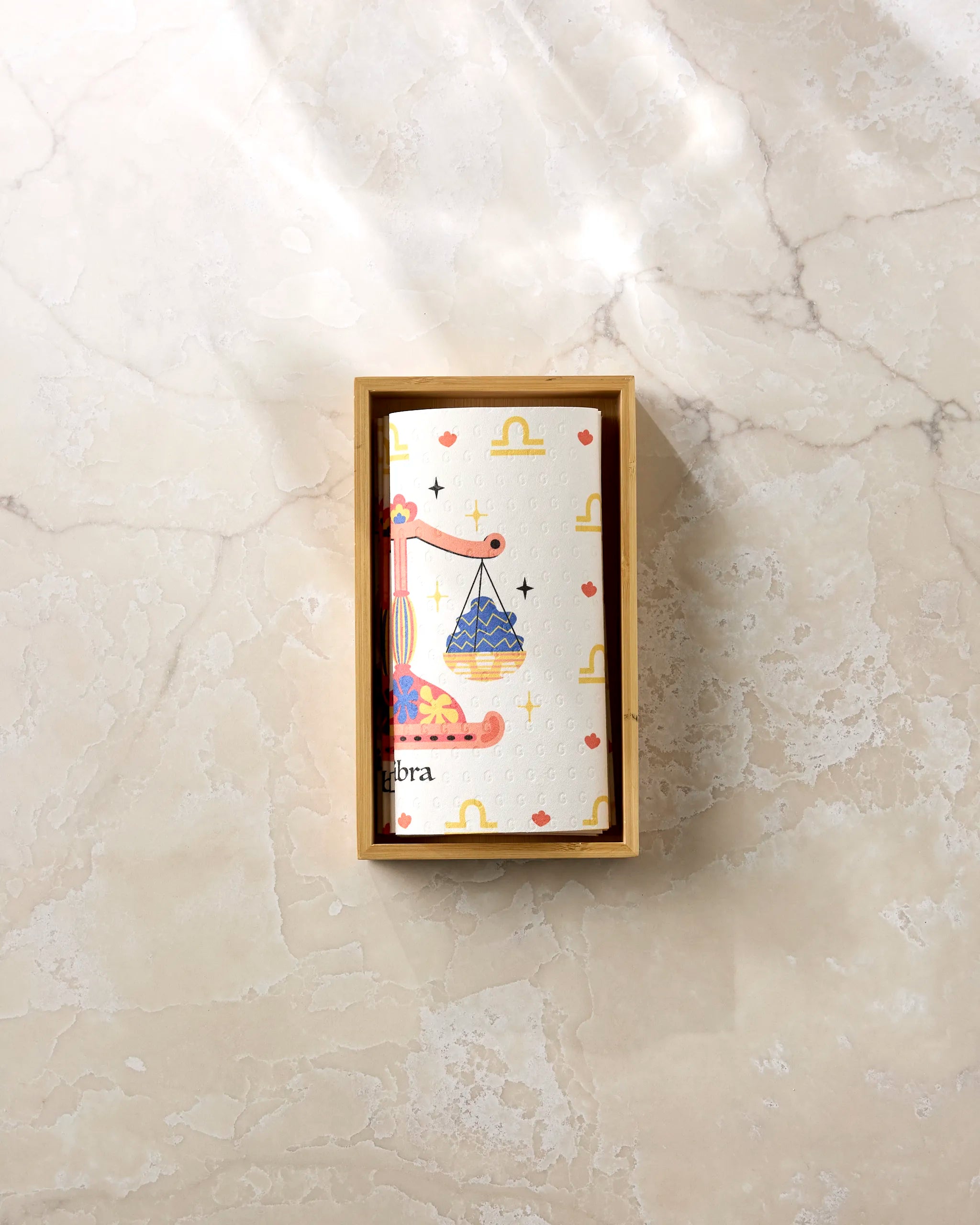 The Heather Zhou "Charming Libra" box features scales, stars, and Libra symbols for an astrological touch—perfect for stylish eco-friendly kitchen towels.