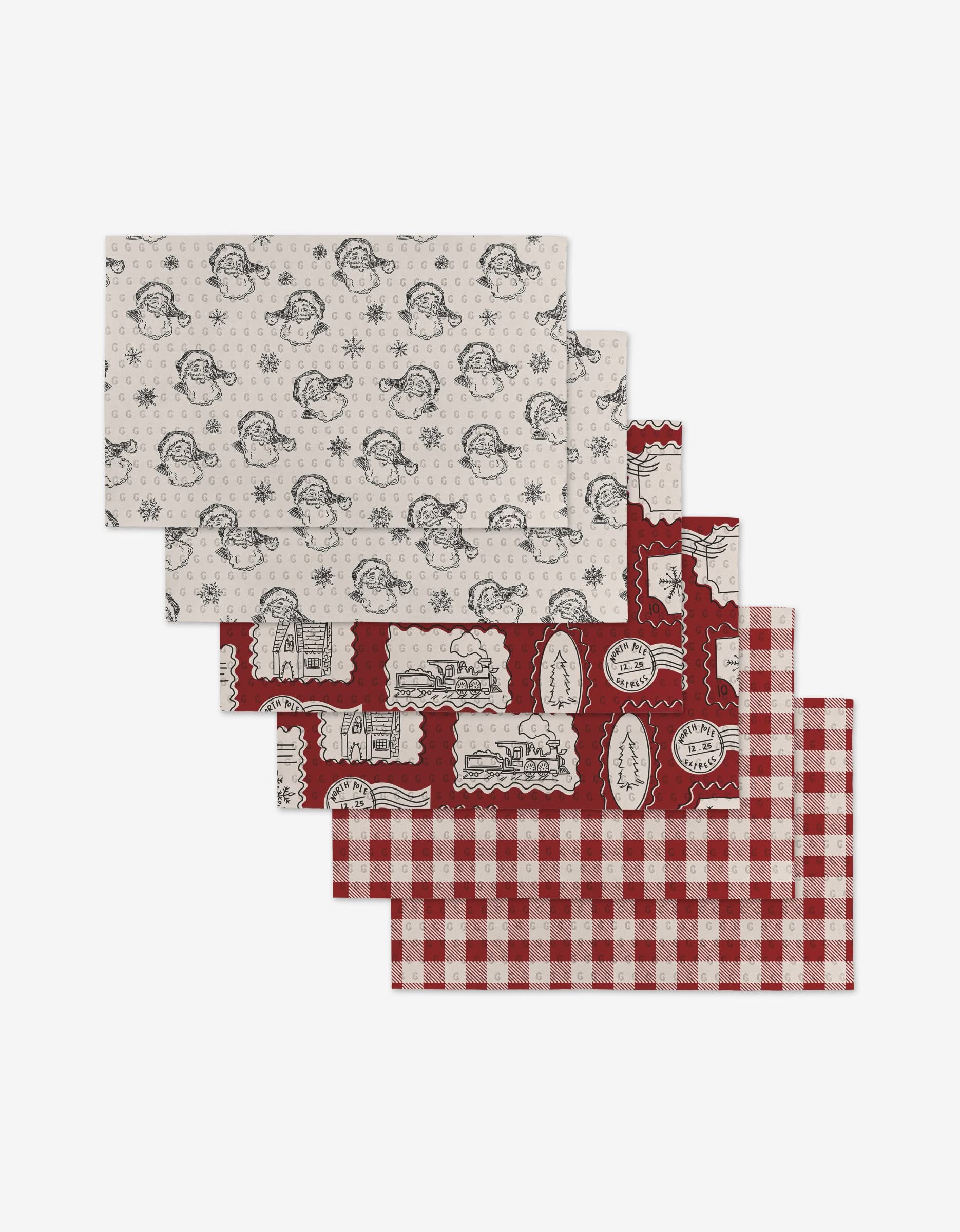 The Aubrey Fairchild Christmas Santa set includes four eco-friendly placemats with snowmen on white, winter postcards on red, holiday motifs on red, and a red-white buffalo check—a sustainable alternative to Not Paper Towels.