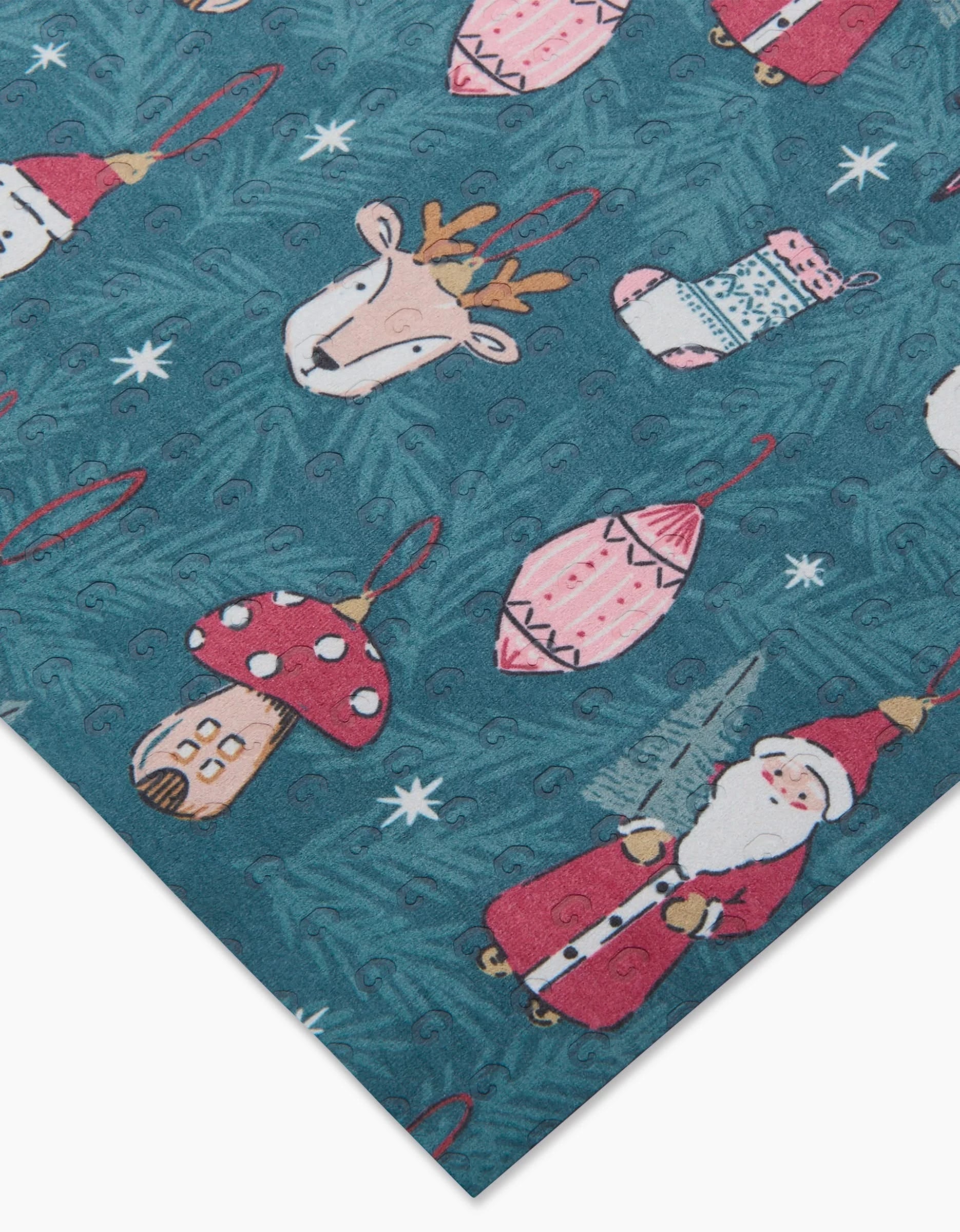 Hufton Studio’s Christmas Traditions is an eco-friendly, machine washable wrapping paper with Santa Claus, reindeer, ornaments, mittens, a mushroom house, and stars on a teal pine-patterned background—perfect for the holidays!.