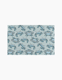 The Mindfulnice Coastal Crew mat features a repeating blue crab and bubble pattern on light gray, inspired by eco-friendly paper towels.