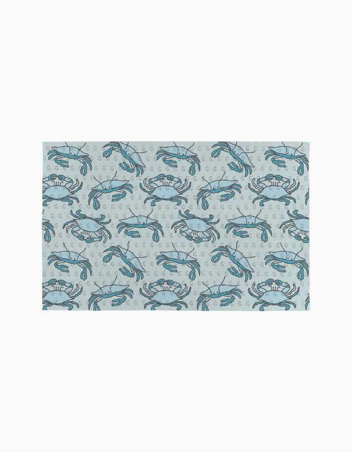 The Mindfulnice Coastal Crew mat features a repeating blue crab and bubble pattern on light gray, inspired by eco-friendly paper towels.
