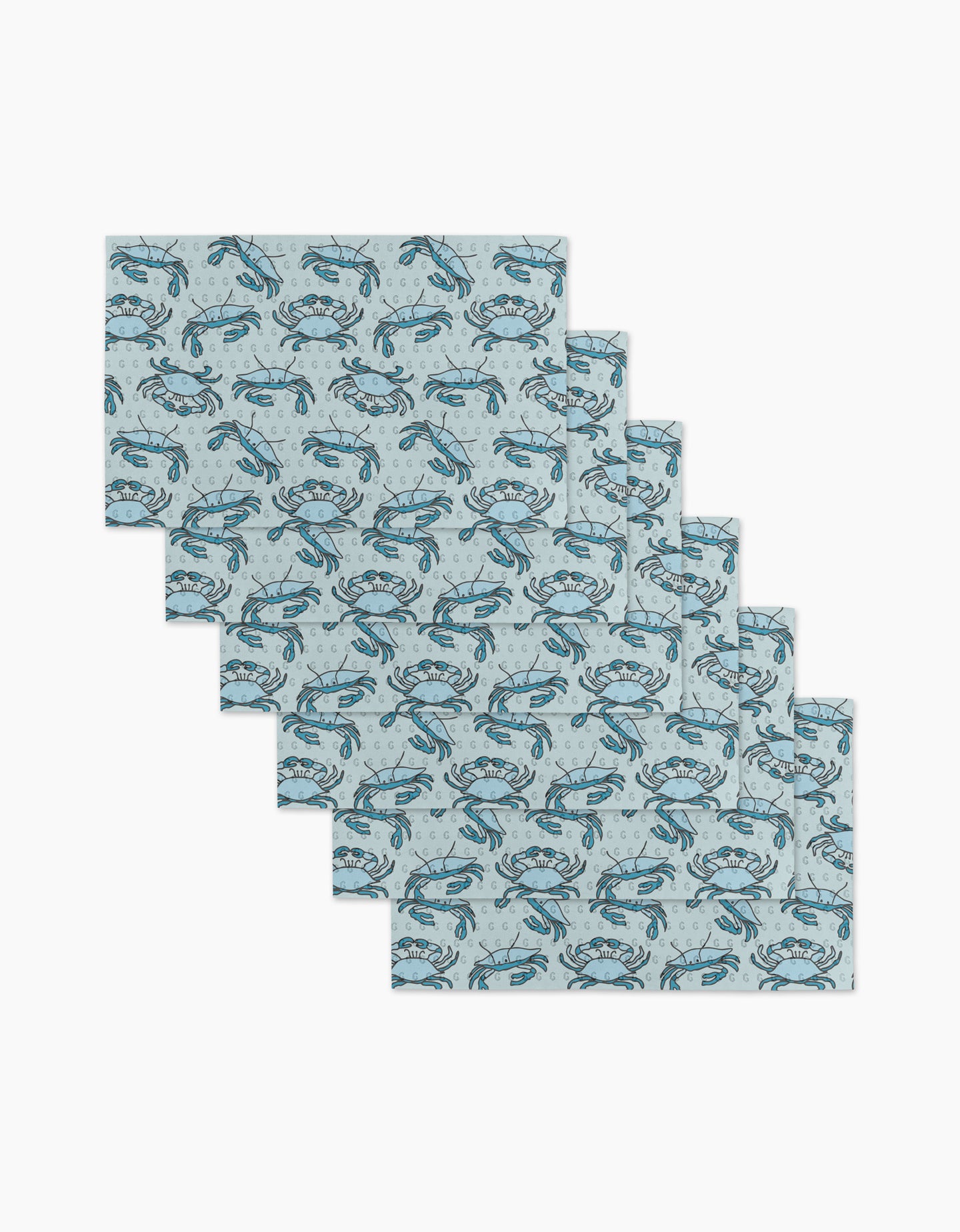 Six Mindfulnice Coastal Crew reusable paper towels with a light blue background and repeating blue crab pattern are arranged in a staggered stack on a white surface.