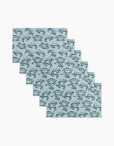 Six Mindfulnice Coastal Crew reusable paper towels with a light blue background and repeating blue crab pattern are arranged in a staggered stack on a white surface.
