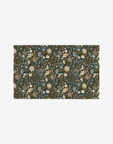 The Danelys Sidron Cottage Meadow Sepia is a reusable rectangular rug with an intricate floral pattern of blue, cream, pink, and white flowers plus green and brown leaves on a dark background.