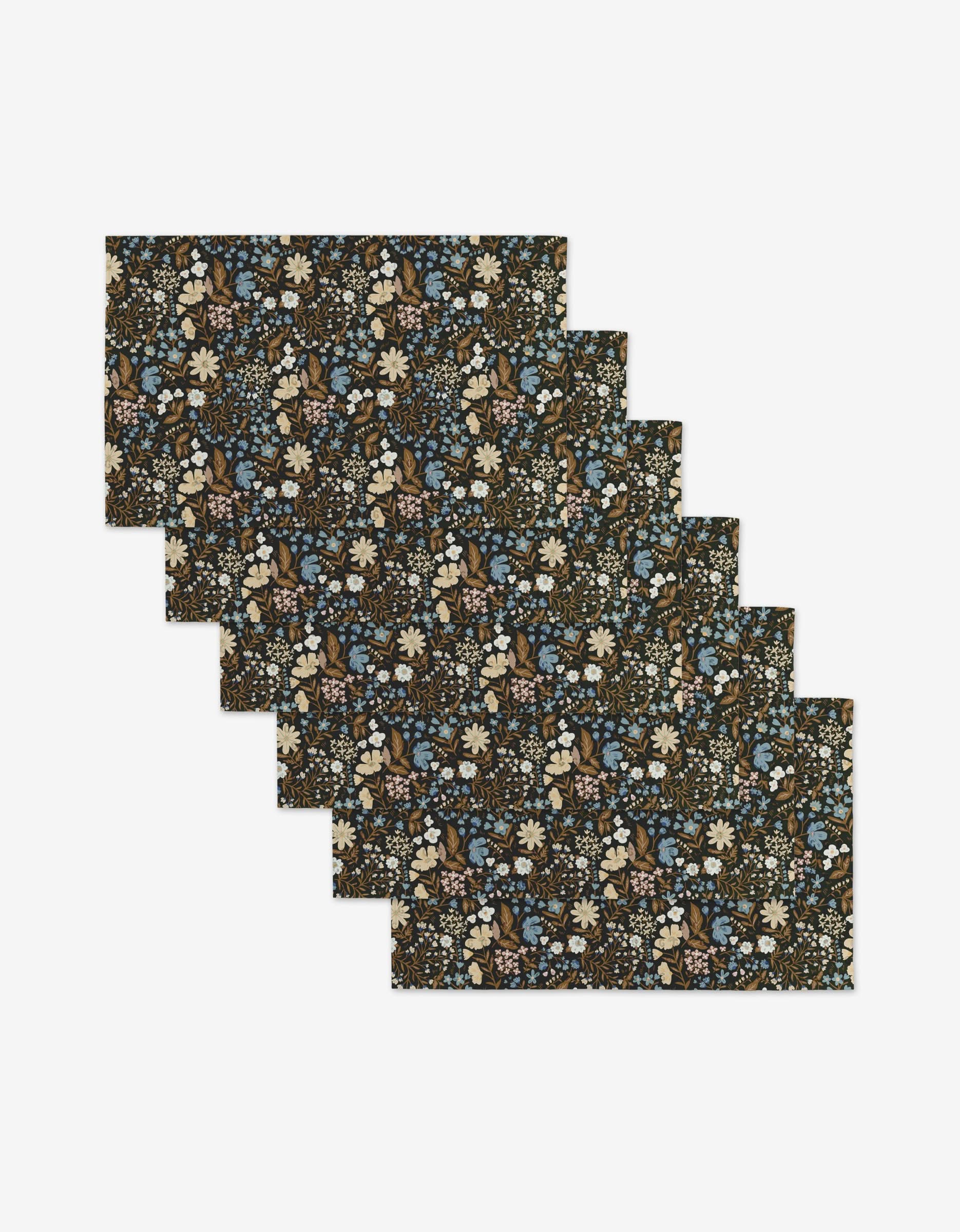 Six reusable rectangular placemats from Danelys Sidron’s Cottage Meadow Sepia collection, featuring a dark floral pattern with blue, white, and beige flowers—an eco-friendly alternative to Not Paper Towels.