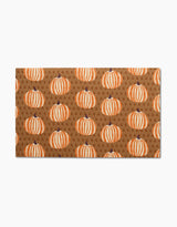 The Dancing Fall doormat by Lizzie Clark features a brown background with orange and white pumpkins and scattered letter Gs—an eco-friendly, charming accent that pairs perfectly with reusable paper towels for your sustainable home.