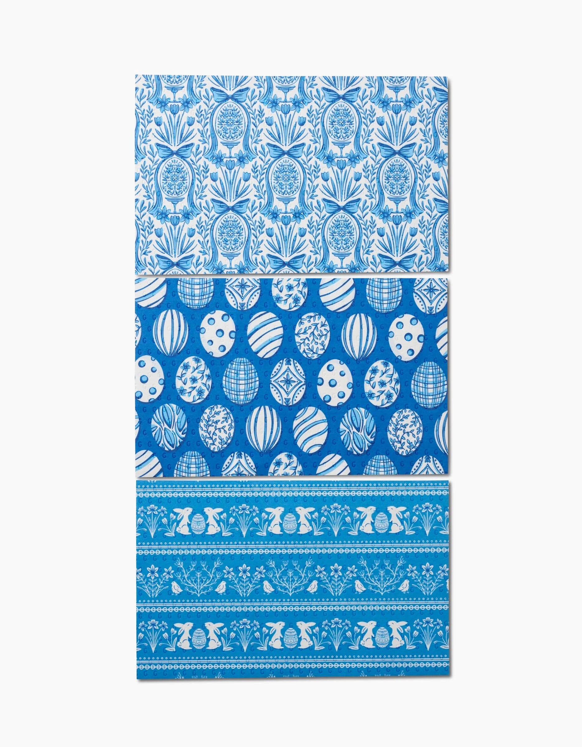 The Delft Blue Easter Eggs and Bunnies by Sarah Daugherty is a rectangular decor piece crafted from recycled paper towels, featuring blue and white florals on top, patterned ornaments in the middle, and geometric floral bands at the base.