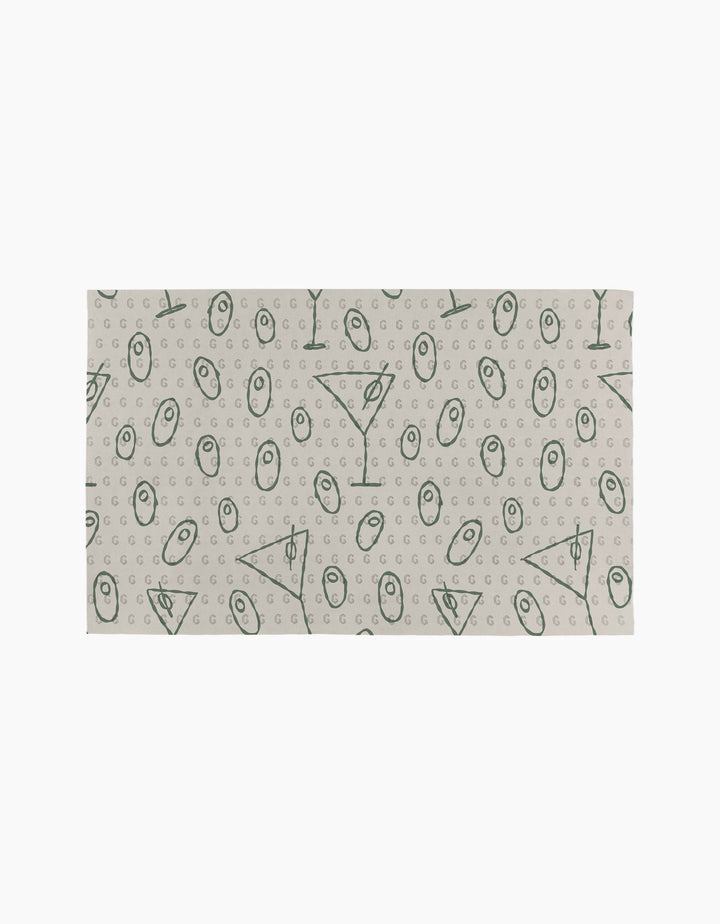 The Dirty Martini by Rosa Kichline is a rectangular cloth with a beige background and green geometric symbols, including circles, triangles, lines, and small Gs—an eco-friendly and stylish alternative to paper towels for your home.